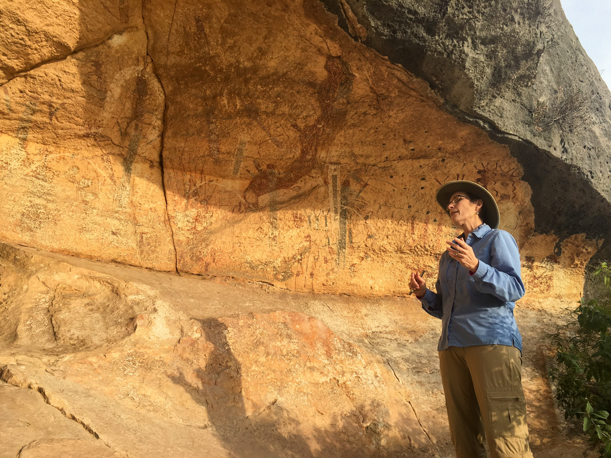 Dr. Carolyn Boyd, founder of the Shumla Center, at the White Shaman Shelter on the Pecos River. The mural here – some 2,000 years old – is one of more than 300 found in the Lower Pecos Canyonlands.  