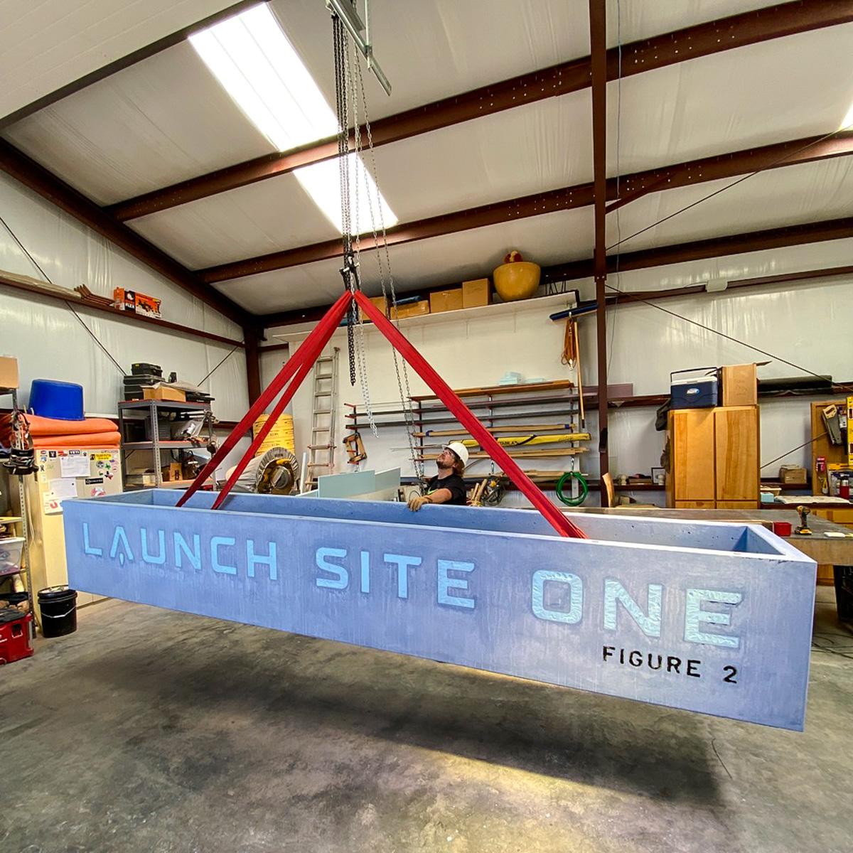 The blue concrete planter is hoisted up at Marfa Cement Works. (Courtesy Photo)