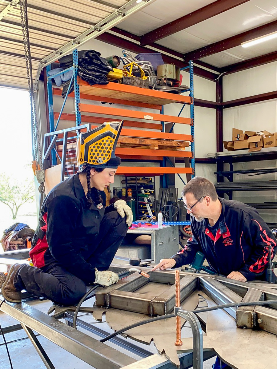 Bella Pena and Bubba Bergeaux work on welding the frame to the stainless steel feather. (Courtesy Photo)