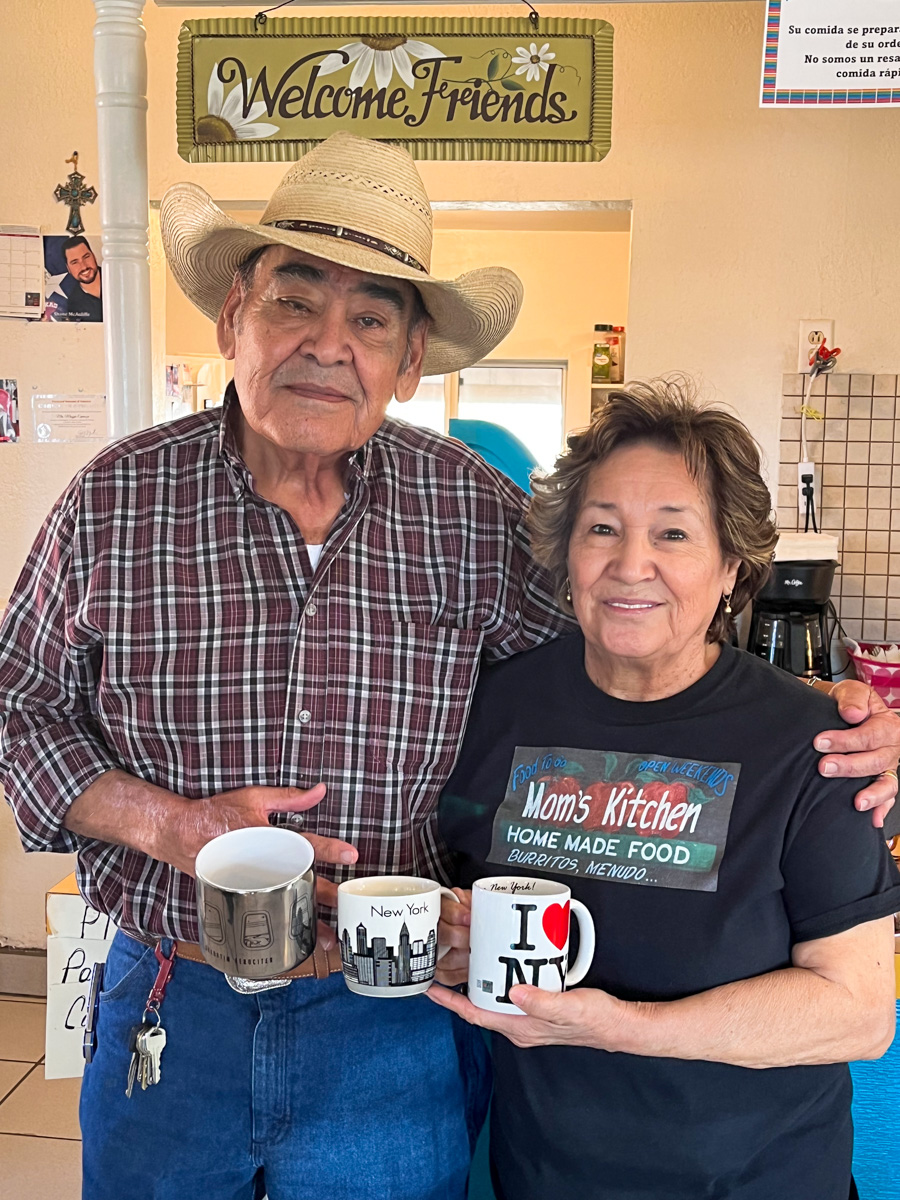 Oscar and Maggie Espinosa hold gift coffee mugs they received from guests from New York City and Blue Origin