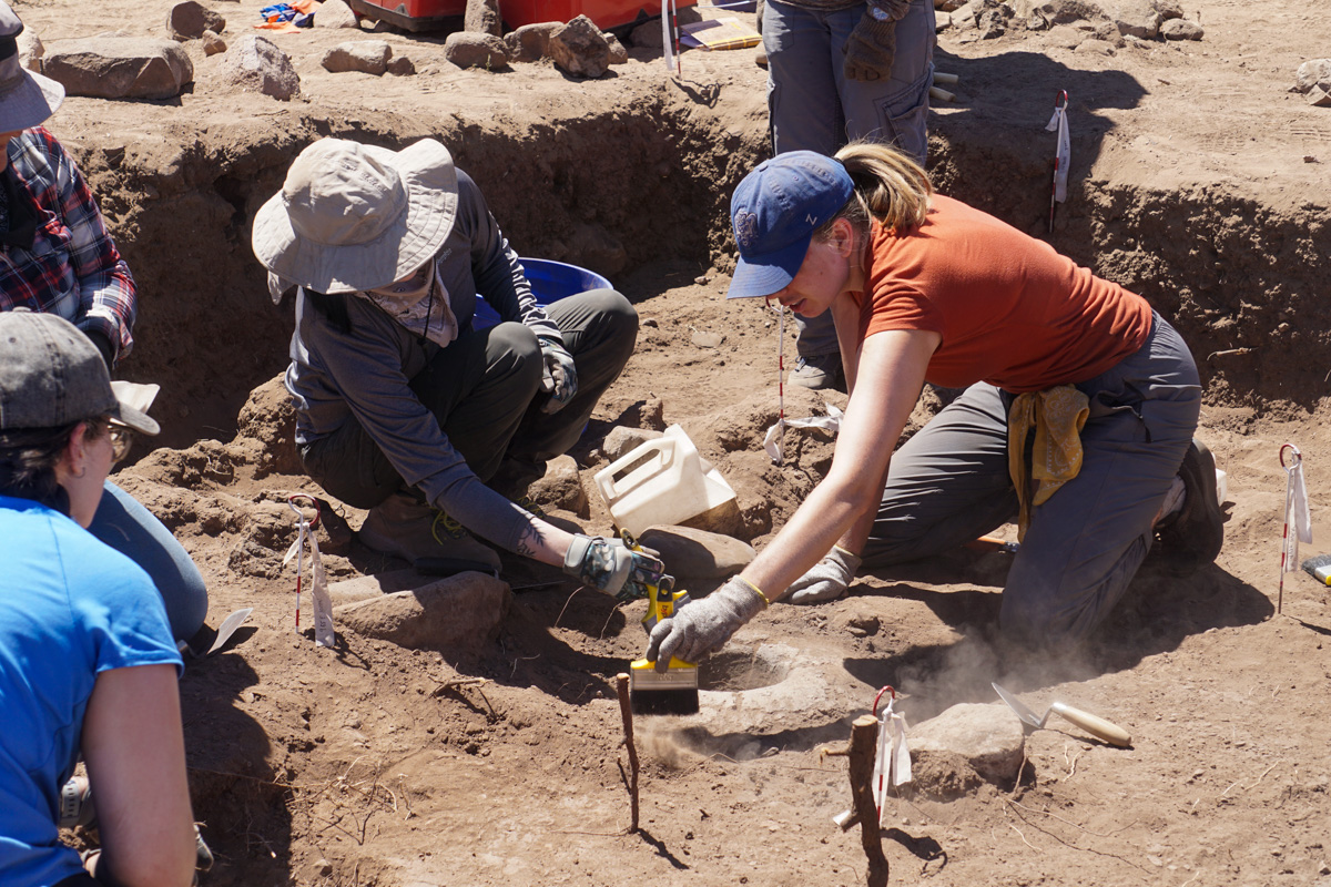 Photograph by Christopher Hillen. Archeologists excavate a hearth at the center of a pithouse, which was likely used for cooking some 1,300 years ago.