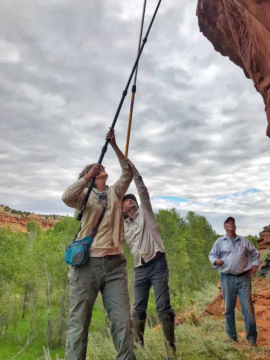 Photograph courtesy Sacred Sites Research. Larry Loendorf, at right, and colleagues use cameras on poles to record rock art images. Photography is just one element of the 10-step approach Loendorf has developed for recording rock-art sites.